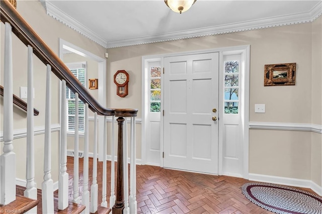 foyer entrance featuring crown molding and a healthy amount of sunlight