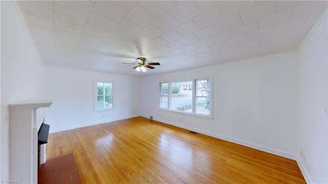 unfurnished living room with hardwood / wood-style flooring and ceiling fan