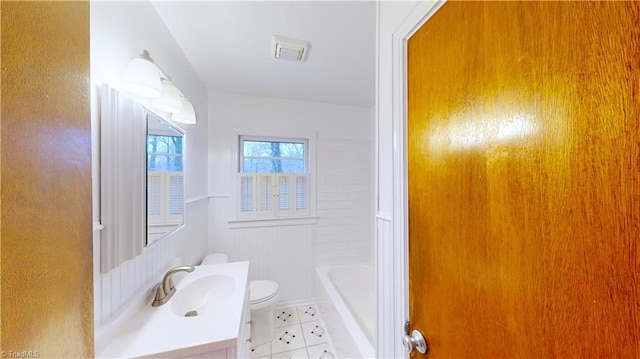 bathroom featuring vanity, toilet, and tile patterned flooring