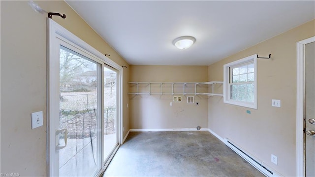 laundry room featuring baseboard heating, hookup for a washing machine, and a wealth of natural light