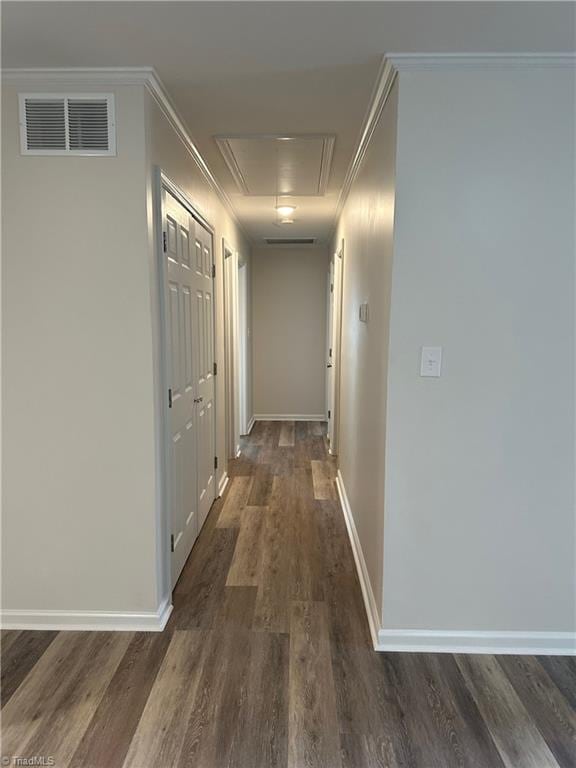 corridor with dark hardwood / wood-style floors and crown molding