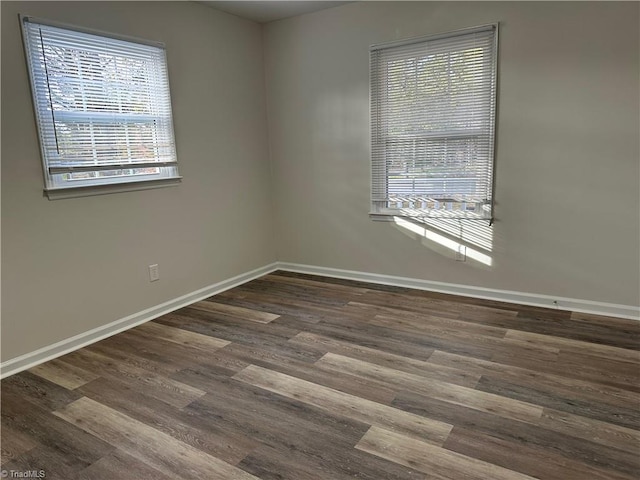 spare room with dark hardwood / wood-style floors