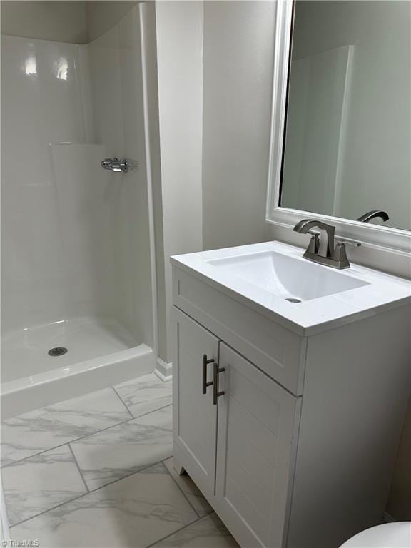 bathroom with a shower and vanity