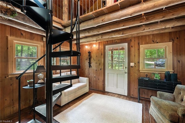 interior space with wood-type flooring and wooden walls