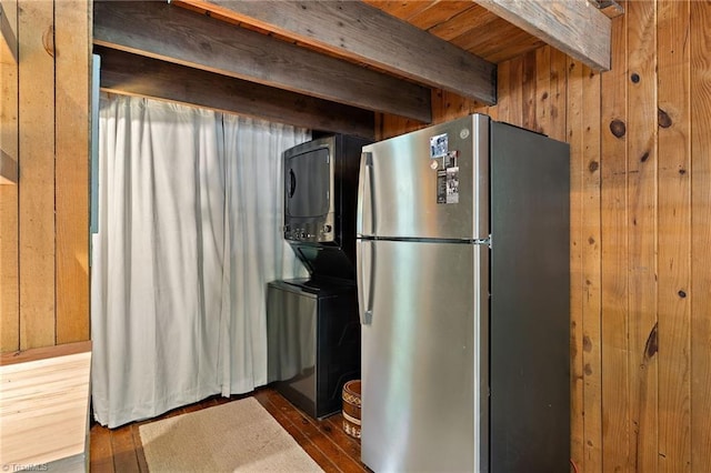 kitchen featuring freestanding refrigerator, beamed ceiling, wood walls, and wood finished floors
