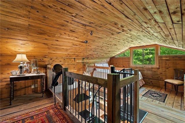 additional living space featuring wood-type flooring, wood walls, wood ceiling, and vaulted ceiling
