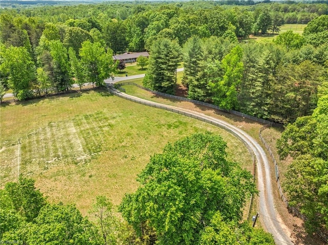 birds eye view of property featuring a wooded view