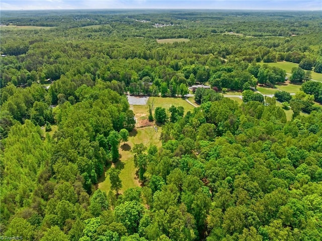 bird's eye view featuring a wooded view