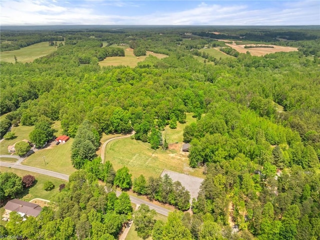 birds eye view of property with a wooded view