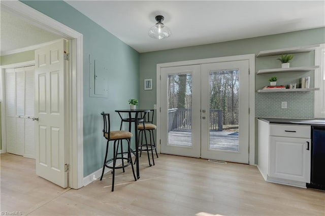 entryway with french doors, visible vents, baseboards, and light wood finished floors