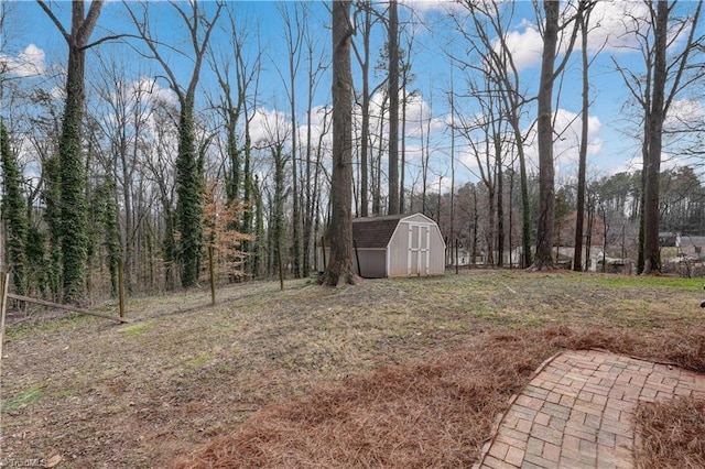 view of yard with an outbuilding and a shed