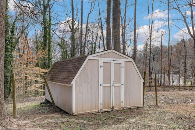 view of shed with a forest view