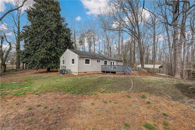 exterior space featuring crawl space, a yard, and a wooden deck