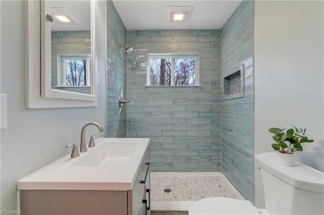 full bath with a shower stall, toilet, and vanity