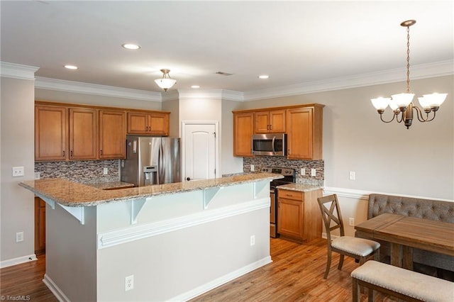 kitchen featuring tasteful backsplash, light hardwood / wood-style flooring, stainless steel appliances, and crown molding