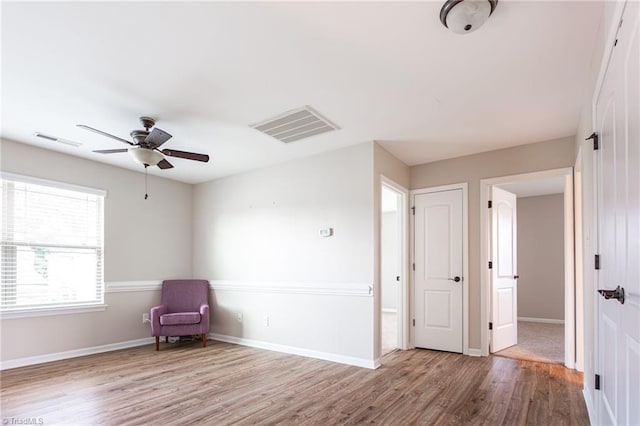 unfurnished room with light carpet and ceiling fan