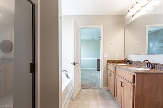 bathroom featuring dual bowl vanity, a bathtub, tile patterned floors, and ceiling fan