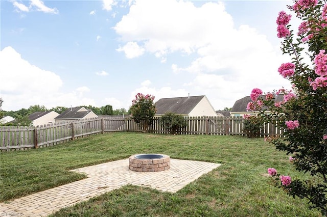 view of yard with a patio and an outdoor fire pit