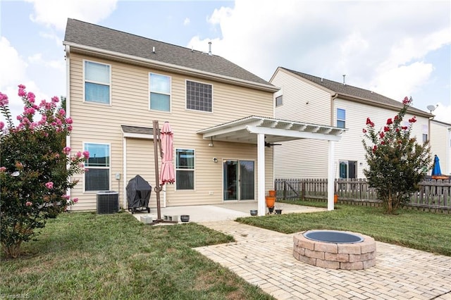 back of property with a pergola, central air condition unit, a patio area, a fire pit, and a lawn