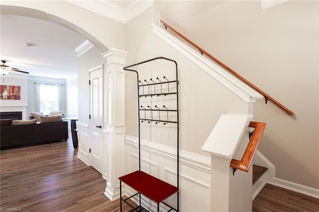 staircase with ceiling fan, wood-type flooring, decorative columns, and ornamental molding