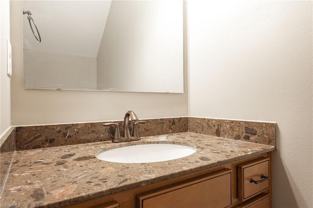 bathroom with vanity and vaulted ceiling