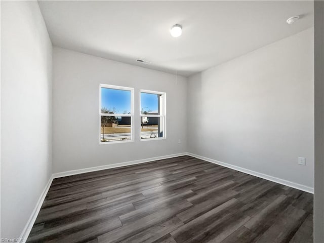 unfurnished room featuring dark wood-type flooring