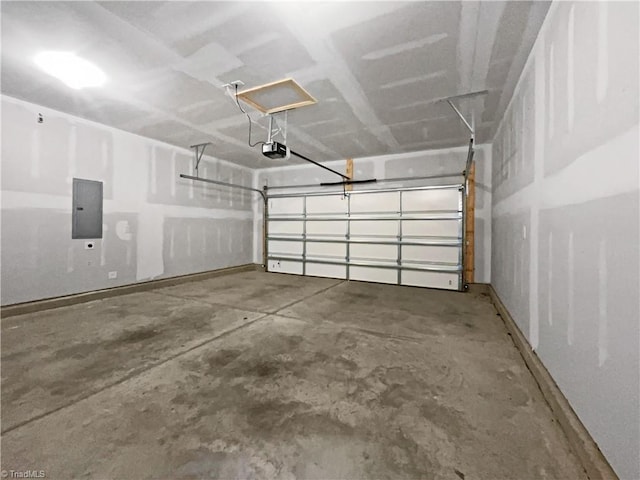 garage with a garage door opener and electric panel