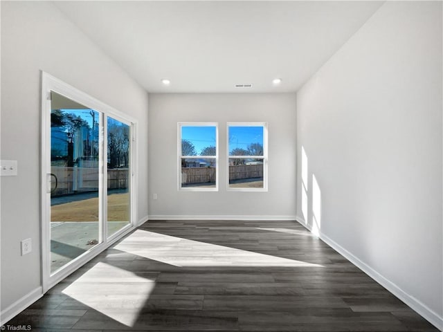 spare room featuring dark wood-type flooring