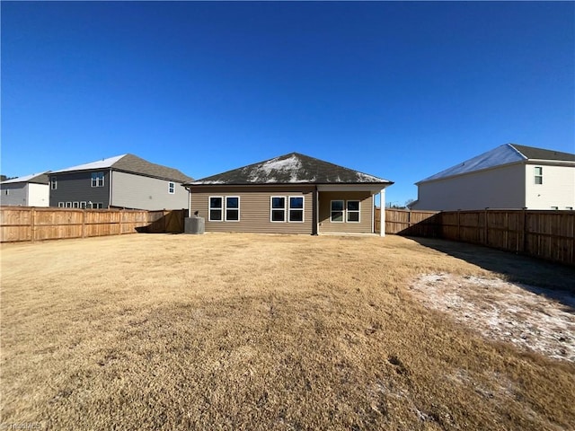 back of house with a yard and central AC