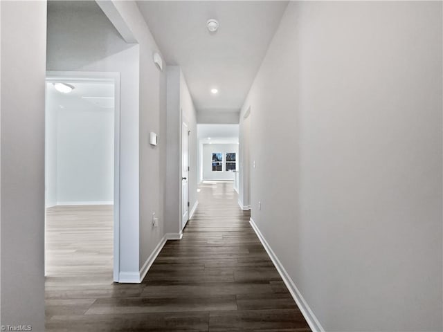 hallway with dark hardwood / wood-style flooring