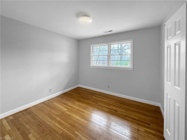 spare room with hardwood / wood-style floors