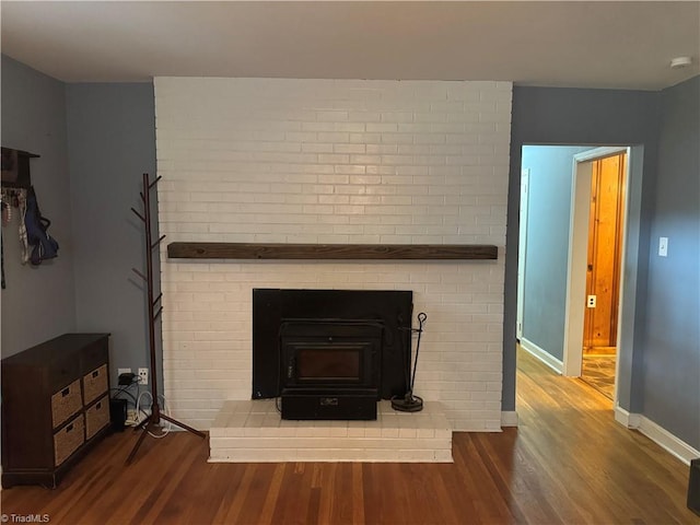 2765 Green Oaks Dr, Winston-Salem, NC 27107 - detailed view of wood finished floors, a smoke detector, and a wood stove