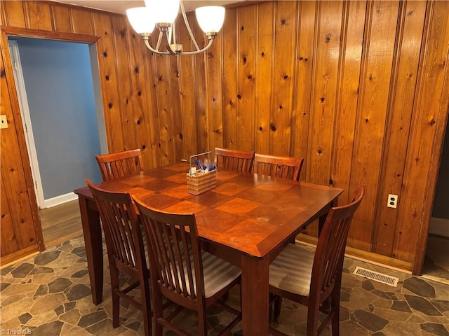 2765 Green Oaks Dr, Winston-Salem, NC 27107 - dining area featuring a chandelier and wooden walls