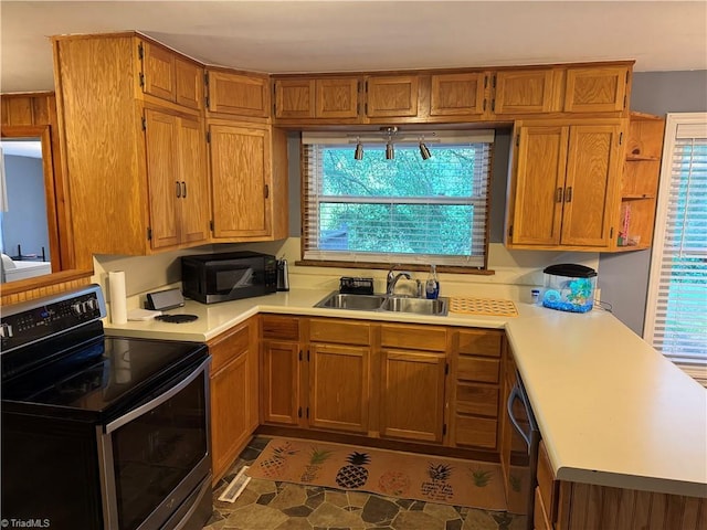 2765 Green Oaks Dr, Winston-Salem, NC 27107 - kitchen featuring electric range oven, black microwave, light countertops, and brown cabinetry