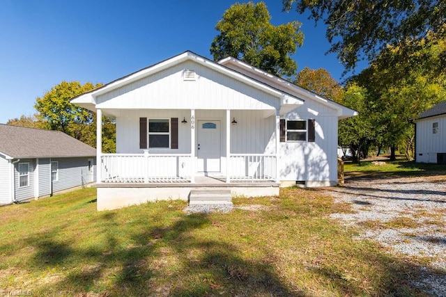 bungalow with covered porch and a front yard