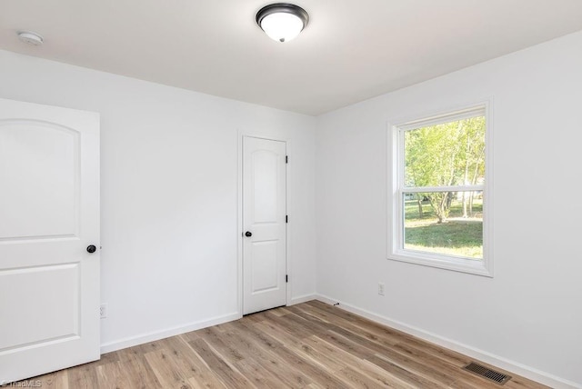 unfurnished room with light wood-type flooring