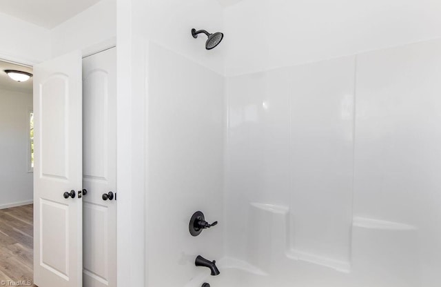 bathroom featuring hardwood / wood-style floors and shower / bath combination