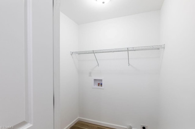 laundry room with hookup for a washing machine, electric dryer hookup, and dark hardwood / wood-style flooring