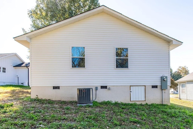 back of house featuring central AC unit