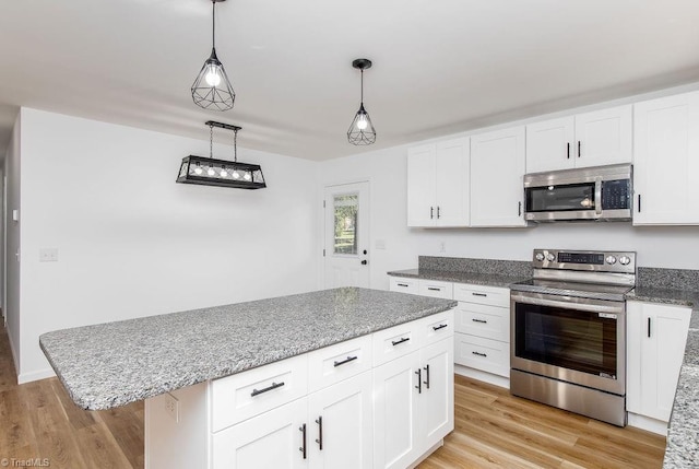 kitchen featuring a kitchen island, white cabinets, stainless steel appliances, and light hardwood / wood-style floors