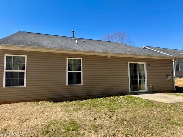 back of house with a yard and a patio area