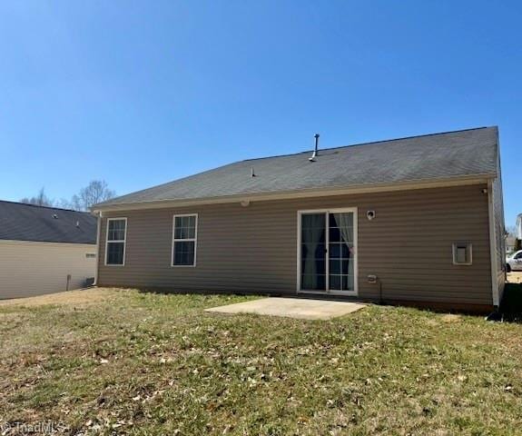 back of house featuring a patio area and a lawn