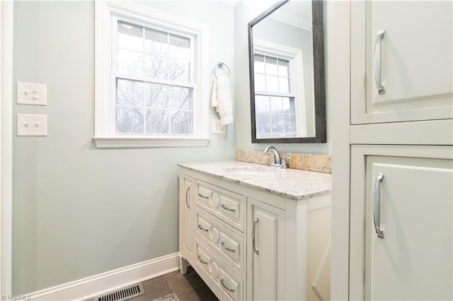 bathroom featuring baseboards and vanity