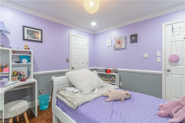 bedroom with crown molding and wood finished floors