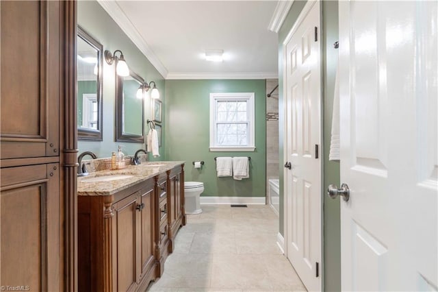 full bathroom featuring double vanity, a sink, toilet, and crown molding