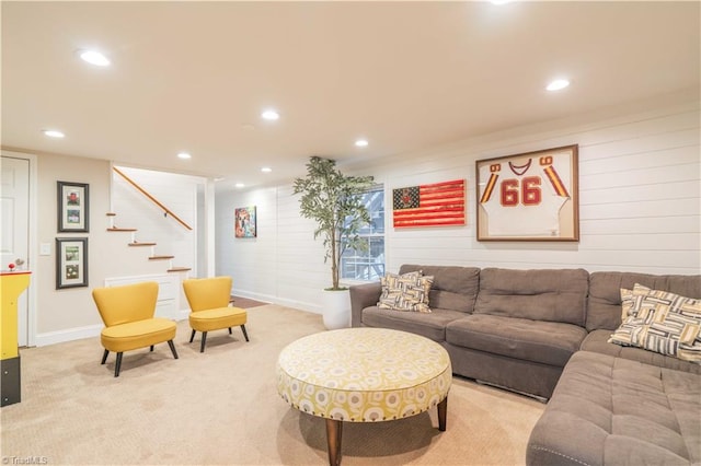 living room with recessed lighting, stairs, baseboards, and light colored carpet