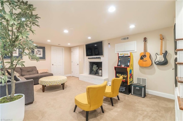 living room with light carpet, visible vents, baseboards, a fireplace, and recessed lighting