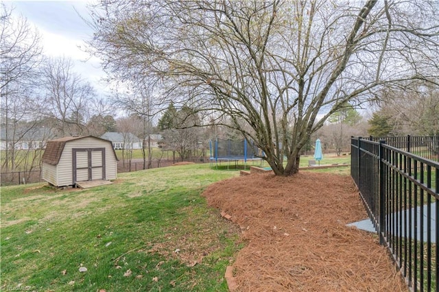 view of yard with a shed, a trampoline, a fenced backyard, and an outdoor structure