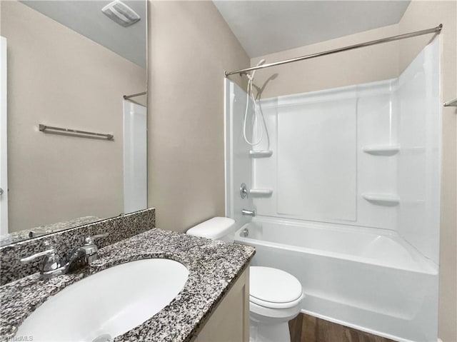 full bathroom featuring toilet, vanity,  shower combination, and hardwood / wood-style flooring