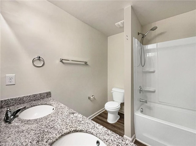 full bathroom with shower / bathing tub combination, hardwood / wood-style floors, vanity, and toilet